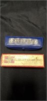 Two vintage harmonicas