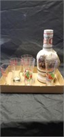 Liquor bottle and six glasses