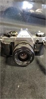 Vintage Canon camera with lenses, flashbar and