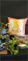 Fake flowers in basket and pillow