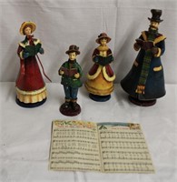 4 Christmas carolers with tin accents and book