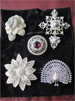 5 silver toned brooches