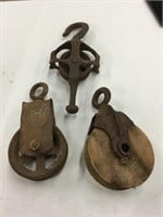 Two metal and one wooden pulley