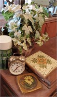 Thermos, alarm clock, trivets, and greenery
