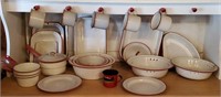 Red enamelware, pans, colanders, plates, mugs