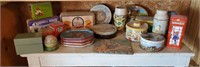 Shelf of tins, thermos, and trays