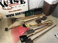 Yard tools and brown trashcan