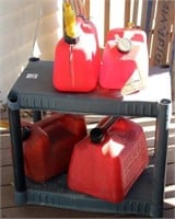 Plastic shelf with 4 plastic fuel cans,