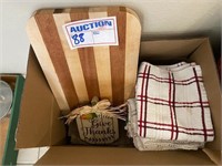 Box of kitchen towels & cutting board