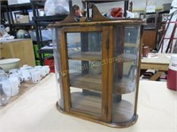 Wooden display cabinet with bowed glass front