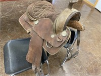 Saddle, brown leather, one stirrup