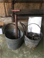 Two old pails with scrap metal and pump