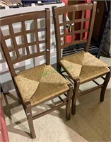 Two side chairs, painted brown, with woven rush