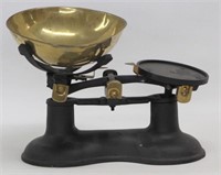 Balance scale with brass colored pan