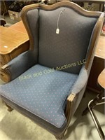 Blue upholstered wing back chair