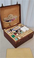 Early leather travel case full of sewing