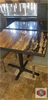 table with metal post, marble like design top.