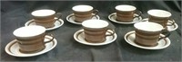 Seven matching cups & saucers
