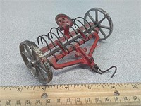 Vintage Arcade cast toy rake