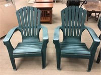 Two Green Plastic Adirondack Chairs