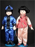Pair 15" porcelain MYD Asian boy and girl dolls