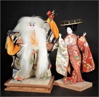 [2] Asian dolls on wood platforms