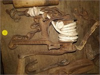 lot of primitives , sad irons , cobblers tools ,