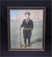 Antique color portrait photo of a boy with his rif