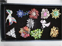 flat of (11) brooches