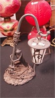 Metal table lamp with full figure of a drunken