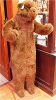 5' plush bear with articulated arms on a wooden
