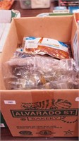 Box of artificial baits including poppers and