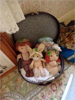 Vintage suitcase with stuffed animals and dolls