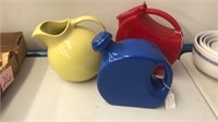 red plastic pitcher yellow hull and blue pitcher