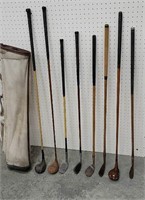 8 Wooden and fiberglass golf clubs with bag