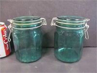 2 green glass canisters