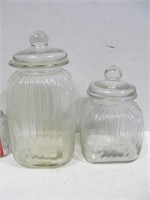 2 glass canisters, sm chip on lid of smaller one