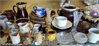 Shelf of Pottery Plates, Pitchers, And More