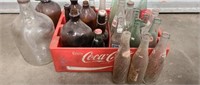 Plastic Coca-Cola crate with vintage jugs/bottles
