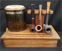 Rack of pipes with tobacco jar on wooden base 6