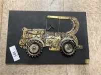 Automobile plaque made from watch parts.