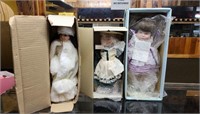 Group of collectible dolls and boxes