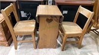 Two child’s chairs and child size side table,