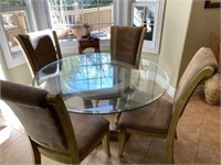 Glass top  dining table and four chairs Has round