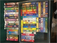 Approximately 4 dozen VHS tapes.