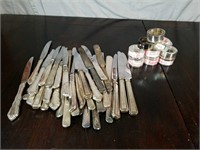 (9) Silver Plated Napkin Rings And Butter Knives