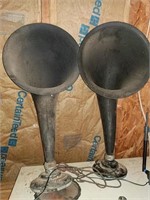 2 horn speakers attached to bases