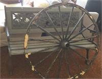 Outdoor park bench and large wagon wheel
