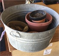 Round metal washtub and clay planter pots