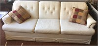 Off-white/cream-colored couch with decorative